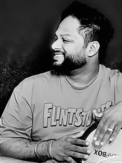 A black and white portrait of me with my darbuka. Besides tabla and dholak, I also play various hand drums like the darbuka to add different textures and global flavors to my recordings.