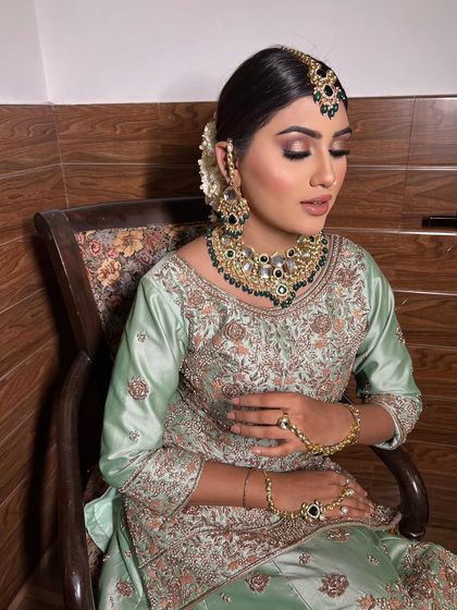 A full view of the subtle Nikkah look. The elegant bun hairstyle and statement jewelry complete the look perfectly. Bridal makeup like this starts from ₹9999 at our studio.