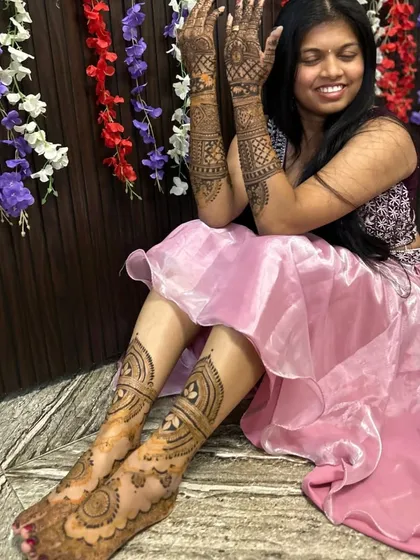 This bride chose to have mehendi on her feet as well as her hands. The designs are coordinated to create a complete and traditional bridal look.