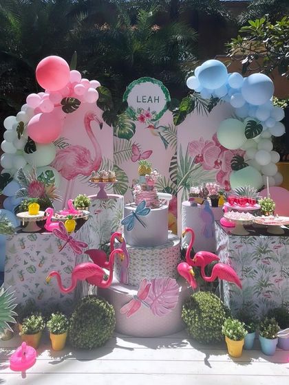 Let's flamingle! A tropical flamingo-themed party with pink and blue balloon arches and plenty of flamingo friends to celebrate with.