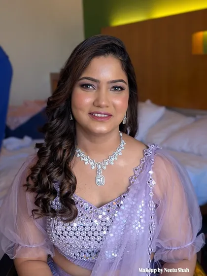 A confident and happy client ready for a wedding party. The soft glam makeup enhances her features without overpowering them.