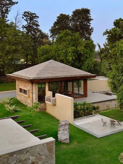 The garden pavilion at C Farm is a study in simplicity and purity of form. With its stone walls, hipped roof, and large glass doors, it serves as a quiet, self-contained retreat within the larger landscape.