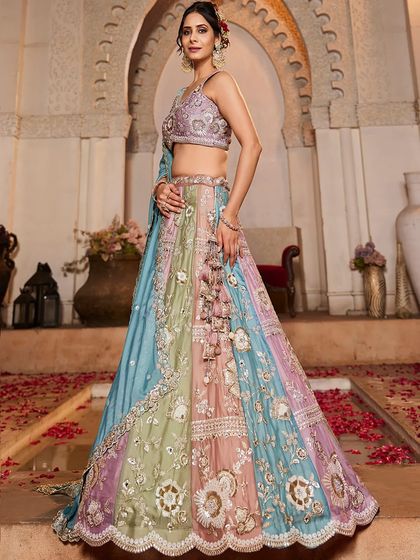 A full shot of the model in the pastel panelled lehenga, looking ethereal and elegant.