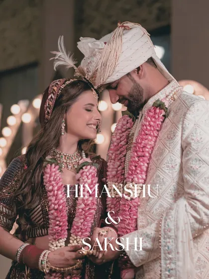 An intimate and romantic close-up of the couple, their garlands symbolizing their union. The soft focus creates a dreamy, fairytale-like feel.