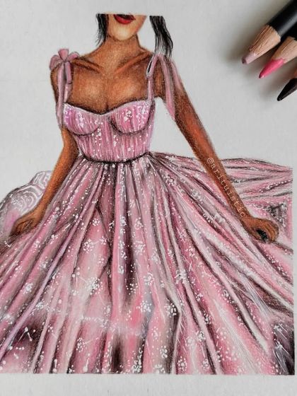 The completed pink dress drawing, shown with the pencils used for the skin tone and dress color.