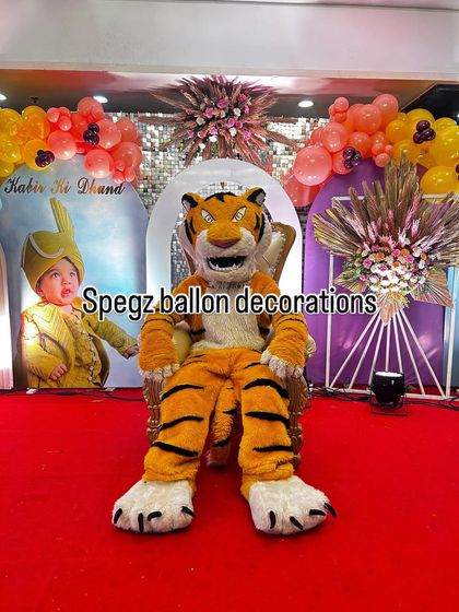 My tiger mascot taking a seat on a throne, perfect for a 'king of the jungle' themed party. This setup creates a fantastic photo opportunity for the guest of honor and adds a regal touch to the celebration.