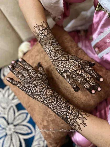 This view showcases the back-of-hand design, which continues the intricate theme from the palms.