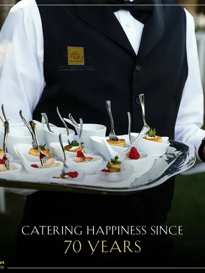Catering happiness for 70 years. Our impeccably dressed server presents a tray of exquisite appetizers, embodying the professionalism and grace we bring to every event.