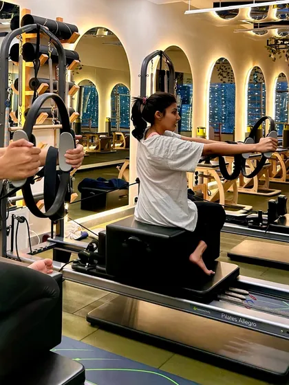 Slaying every stretch with the help of the magic circle. This move on the reformer box targets the arms and core.