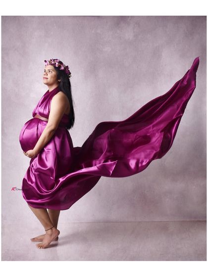 A vibrant magenta satin gown with the fabric tossed to create a dramatic, wing-like shape. This is a great option for a bold and colorful fine art portrait.