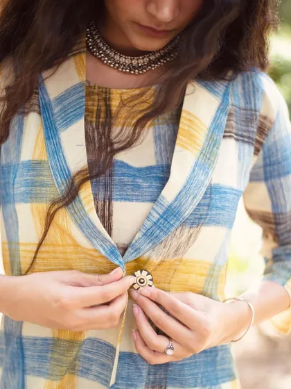 For e-commerce, the details make the sale. This close-up focuses on the unique button and the rich texture of the fabric. It allows customers to appreciate the craftsmanship of the garment, building trust and giving them a tangible sense of the quality before they even add it to their cart.