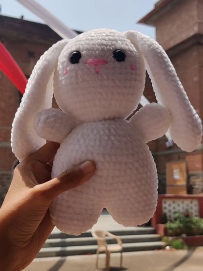 This big, fluffy white bunny plushie is made with super soft yarn.