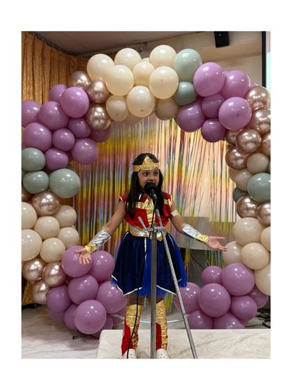 Wonder Woman addresses the audience, a perfect example of how costumes help children step into character and perform fearlessly.