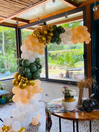 A side view of the beautiful balloon arch, showing its placement in a sunlit room.