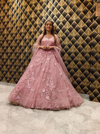 A full-length shot of the pink gown against a stylish backdrop.