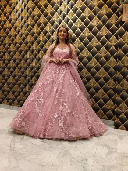 A full-length view of the pink floral gown, a perfect rental for a fairytale-themed event.