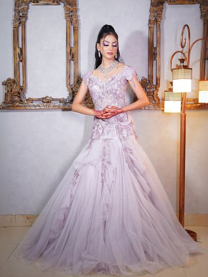 This lilac gown with a sheer, embroidered overlay is perfect for a soft and romantic look.