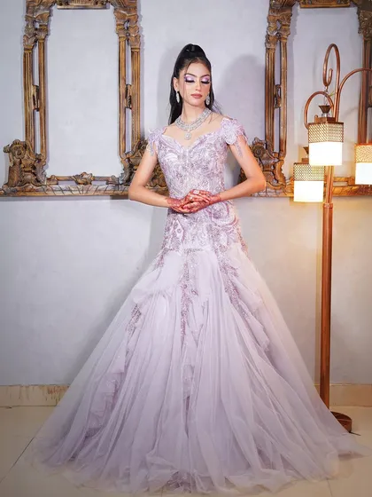 This lilac gown with a sheer, embroidered overlay is perfect for a soft and romantic look.