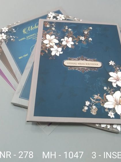 This invitation set features a beautiful floral design on a deep blue background. The transparent floral overlay adds a layer of sophistication to the card.
