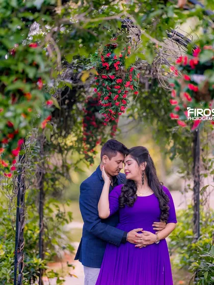 An intimate portrait of a couple under a floral archway, a perfect spot for a romantic and secluded photo.