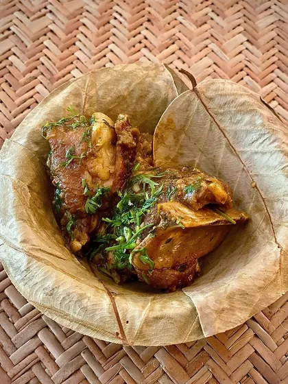 A serving of my slow-cooked mutton, seasoned with fresh coriander and served in a traditional leaf bowl.