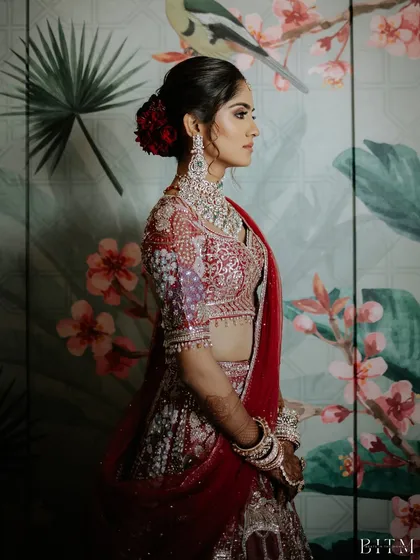 A stunning side profile showcasing the complete look, from the intricate hairstyle to the detailed embroidery on the lehenga.