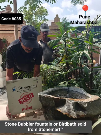 This image captures the moment a sold sign is placed next to the stone bubbler fountain, ready for the next step in its journey.