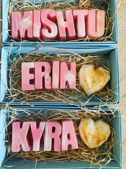 Personalized name soaps in pink and white marble, paired with a gold-dusted heart soap, making a comeback for Rakhi gifting.