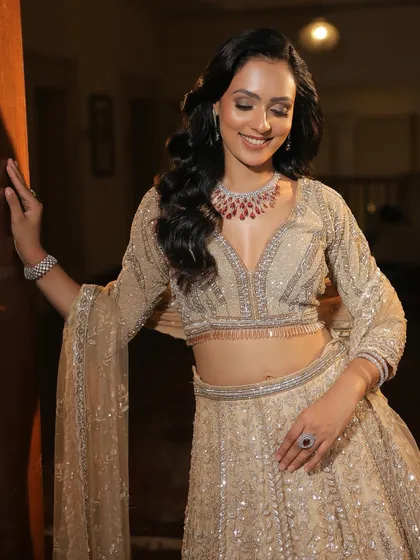 A happy, smiling bride ready for her sangeet. The soft glam makeup looks beautiful and feels comfortable, perfect for a long night of celebrations.