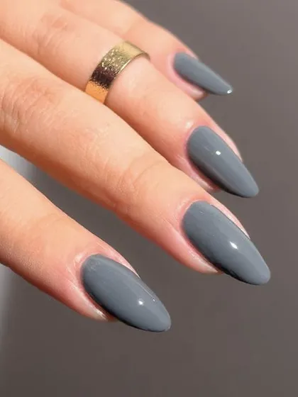 A cool-toned grey polish on almond nails. This is a modern and chic alternative to a classic nude.