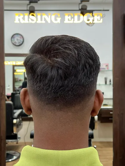 The back of the head shows the precision of the fade. I ensure a smooth transition from the skin to the length on top for a flawless finish.