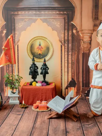 A classic standing portrait of the 'Chota Varkari' holding cymbals, looking directly at the camera with a sweet expression.