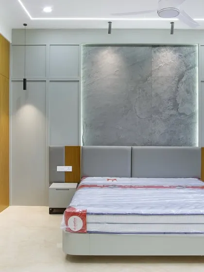 The full view of this bespoke bedroom, showcasing the seamless integration of the granite feature wall, padded headboard, and minimalist nightstands. It’s where function meets form.