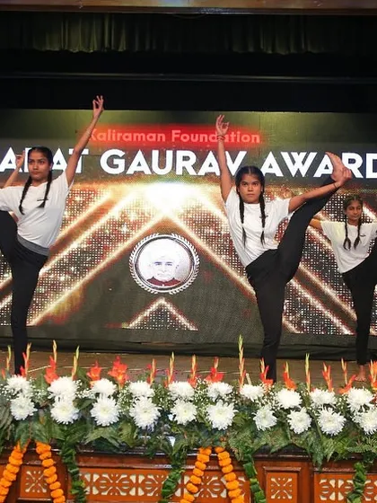 My students holding a synchronized standing leg raise, a testament to their balance and core strength during the Bharat Gaurav Award performance.