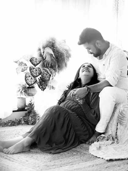 A joyful and candid black and white moment, capturing the couple's laughter and love.