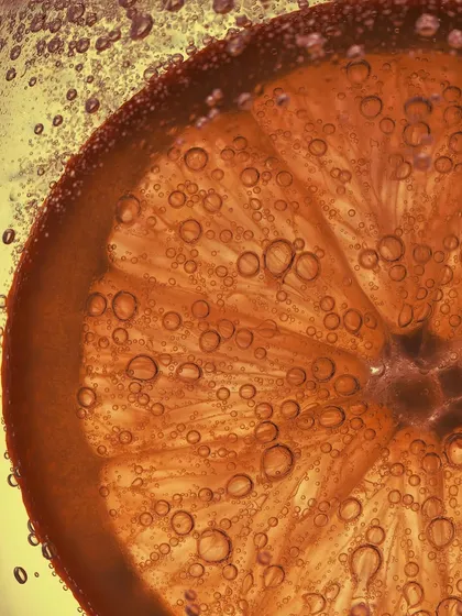 Summer in a glass. This is an extreme macro shot of an orange slice in a fizzy cocktail. I love capturing the texture of the fruit and the tiny bubbles that cling to it.