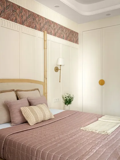 A close-up of the bedding, showing the rich textures and soft colors that define this room. The design is high-end, yet deeply personal.