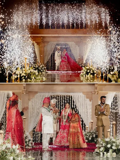 A composite image showing two key moments of the Varmaala ceremony. The top frame captures the couple's exchange under a shower of pyrotechnics, while the bottom shows them with their family, all beautifully framed by the elegant decor.