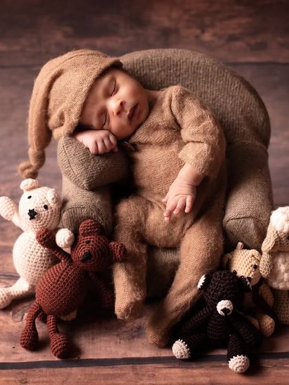 Our little sleepyhead surrounded by his teddy bear friends. This setup is perfect for a classic, cuddly, and heartwarming baby portrait.
