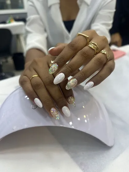White and gold glitter nails, a perfect choice for a festive or bridal look. Our students learn to create clean, professional-looking extensions.