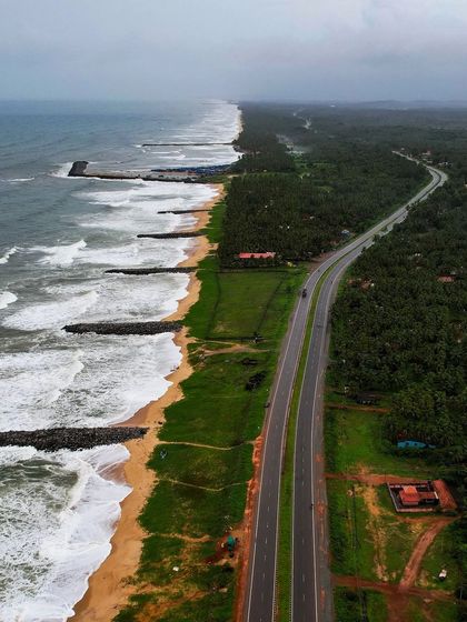 The stunning Maravanthe beach, where the highway runs between the Arabian Sea and the Souparnika River.