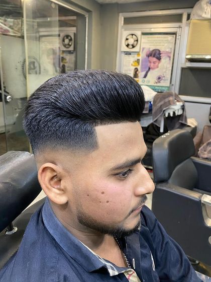 A side view of a classic pompadour with a smooth, blended fade. This is a versatile look for any occasion.