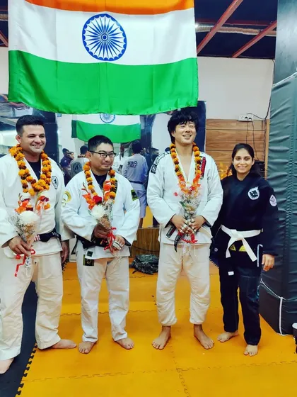 Standing with visiting BJJ practitioners at our dojo. We welcome martial artists from other schools to train with us, as it enriches our learning and strengthens the entire community.