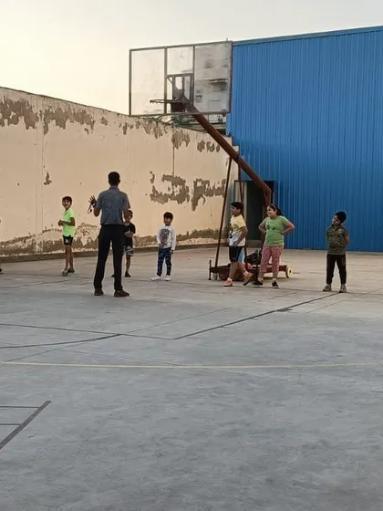 A group of young players gathered on the court to receive instructions from the coach. Clear communication and strategy are a big part of my coaching philosophy.