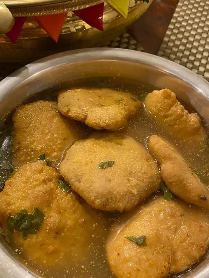 Kanji Vada is a traditional festive delicacy. These are soft lentil fritters soaked in a tangy, mustard-flavored fermented drink, offering a unique and refreshing taste.