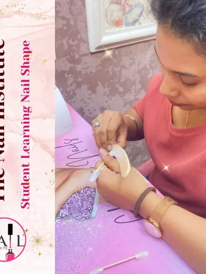 A student practices shaping a nail tip, learning how to create different styles like square, oval, and stiletto.