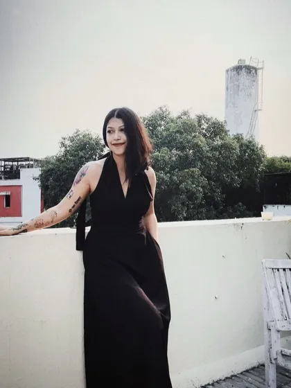 A self-portrait on my rooftop in a classic black dress from Doodlage. It’s about feeling good in what you wear, even in your own space.