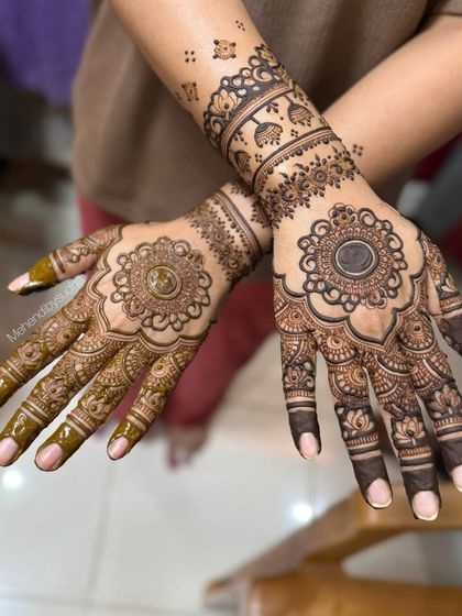 Another view of the engagement mandala design, showing the difference in stain color as the henna paste dries.