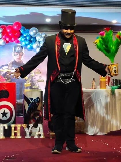 A grand pose with my appearing flower bouquet at a Captain America themed birthday party. My classic magician costume and props create an authentic magical experience.