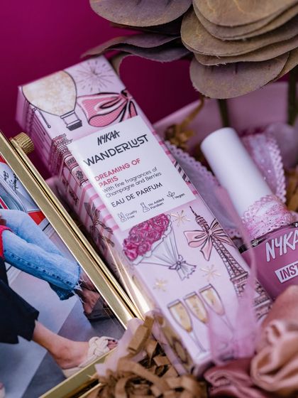 A close-up on the fragrance and nail polish, showing the attention to detail in selecting complementary products.